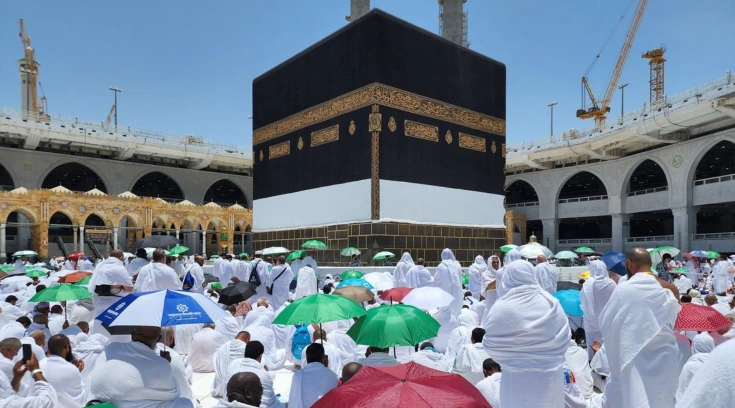 pilgrims are sitting inside the Masjid ul Haram, during Hajj